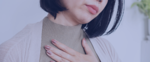 An anonymous woman holding her hand to her chest, as if trying to calm her fast beating heart from panic attacks.