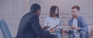 Young couple going through family mediation with a counsellor.