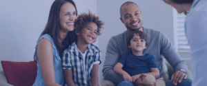 Husband, wife and two young boys attending a parenting skills workshop.